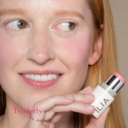 ILIA Multi-Stick - Shade: Tenderly (LIGHT WASHED PINK WITH BLUE UNDERTONES) on fair skinned model - AILLEA