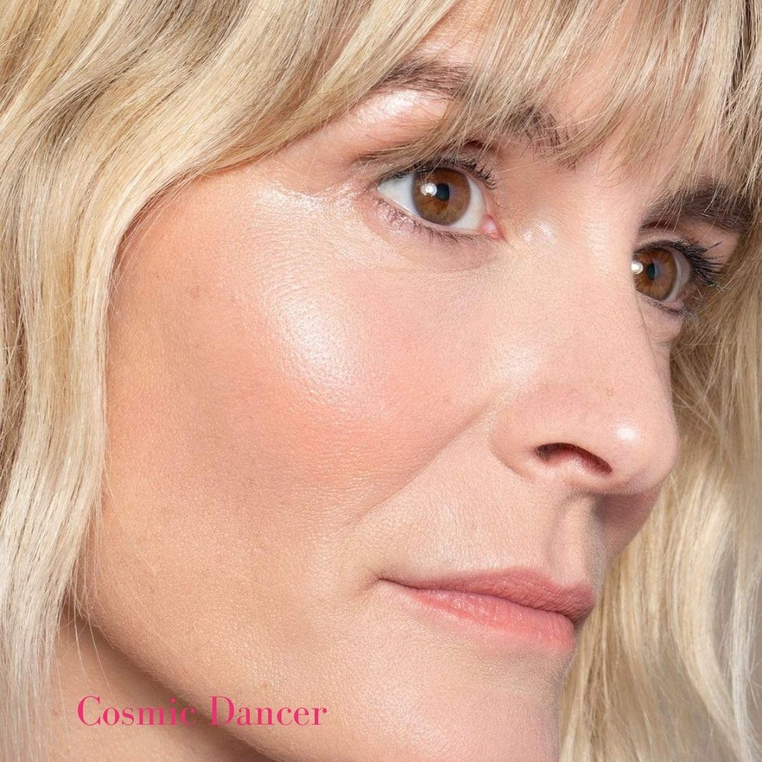 ILIA Illuminator in Cosmic Dancer on Model&#39;s cheek - Soft Gold Highlight - AILLEA